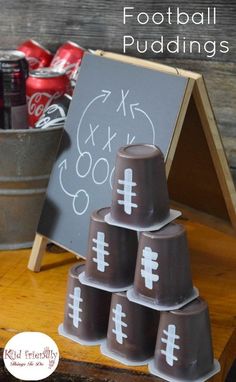 a chalkboard with football puddings on it in front of buckets of soda