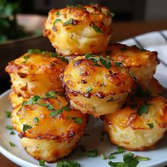 some food is on a white plate with parsley sprinkled around it's edges