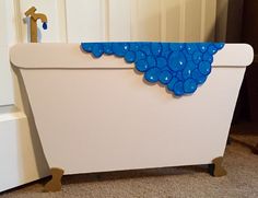 a white bath tub with blue bubbles on the side and an anchor in the middle