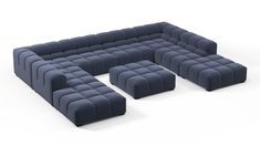 a large blue couch sitting on top of a white floor next to two smaller ones