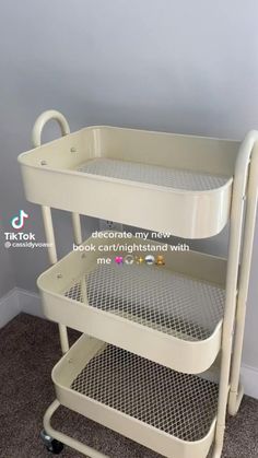 a three tiered white plastic cart with wheels