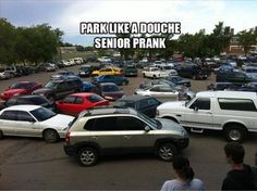 a parking lot filled with lots of cars and people looking at them in the distance