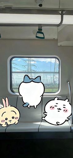 the interior of a train with cartoon characters on it's windows and in between them is an image of a cat, bunny, and rabbit