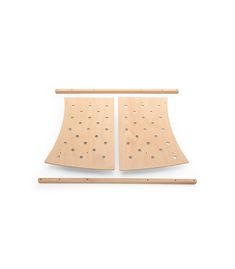 two pieces of wood sit next to each other on top of a white surface with holes in it