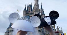 two mickey mouse ears with happily married written on them in front of a disney castle