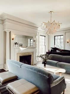 a living room filled with furniture and a piano in the middle of it's walls