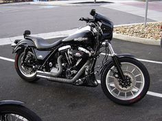 a black motorcycle parked in a parking lot