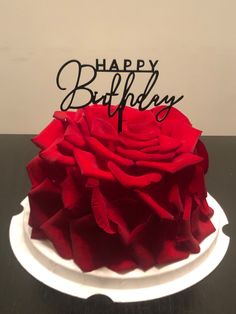 a birthday cake that is decorated with red roses and the words happy birthday written on it