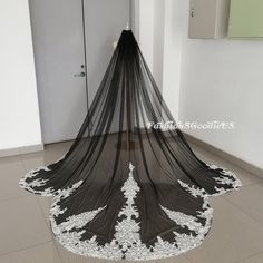 a black and white wedding veil on the floor