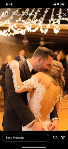 a man and woman are dancing together in a dance hall with lights overhead on the ceiling