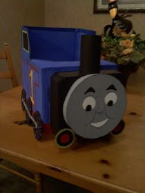 a birthday cake made to look like a thomas the tank engine on a wooden table