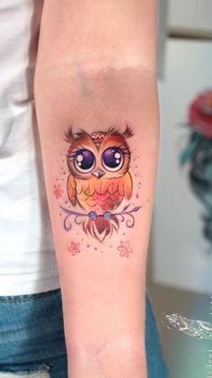 an owl tattoo on the arm