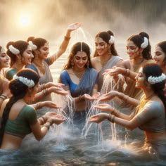 a group of women standing in the water with their hands out to touch each other