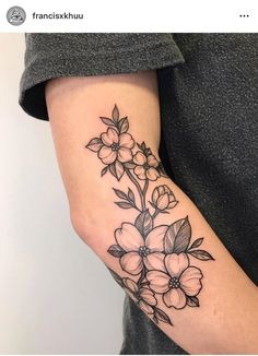 a black and white flower tattoo on the arm