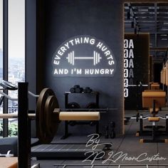 an image of a gym room with dumbs and barbells on the wall