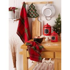 a wooden table topped with lots of christmas decorations next to a pot and pan on top of it