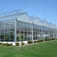 a large glass building with lots of plants in it