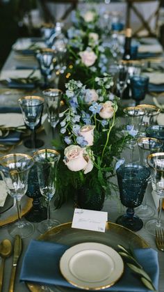 a long table with blue and white place settings