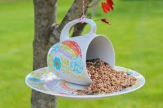 a bird feeder hanging from a tree with the words easy kids project bird feeder