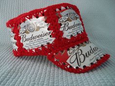 two budweiser beer bottle caps on a bed