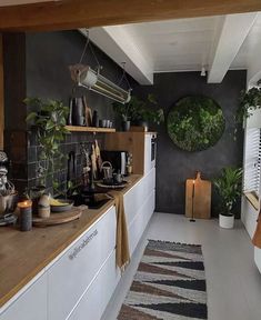 the kitchen is clean and ready for us to use it's counter tops are covered in plants