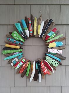 a wreath made out of old clothes pegs