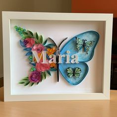 a colorful butterfly with the word maria in it's center surrounded by flowers and butterflies