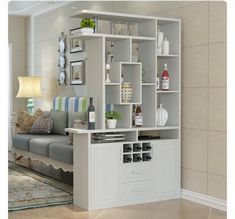 a living room with a couch, coffee table and shelves on the wall above it