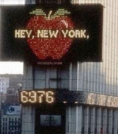 the new york times building has an apple on it's front and is lit up