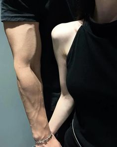 a man and woman holding hands while standing next to each other