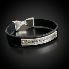 "This bracelet is made with top quality genuine cowhide flat black 10mm (approx 3/8\") leather.  The Flat Snap clasp features a secure closure that makes it easy to get on/off. The bracelet features a sterling silver plate (approx. 1.5\" x .25\") that you can personalize with handwriting, signature, custom text, special dates, etc..  The sterling silver plate is riveted to the leather.  We suggest adding 1/2\" to your wrist measurement for a comfortable fit. FAQ's *If your order includes fingerp Classic Black Leather Bracelet Engraved, Classic Black Engraved Leather Bracelet, Adjustable Hand Stamped Leather Bracelet, Classic Leather Bracelets With Engraving, Black Engraved Leather Bracelet, Classic Engraved Leather Bracelets, Custom Handwriting Jewelry, Handwriting Signature, Meaningful Gifts For Her