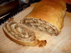 a sliced loaf of bread sitting on top of a wooden cutting board