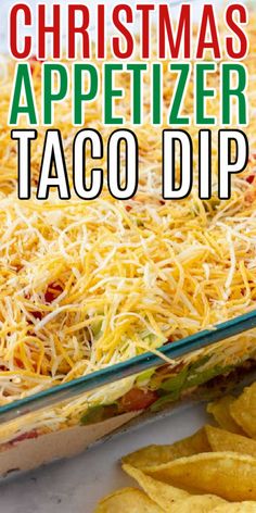 christmas appetizer taco dip in a casserole dish with tortilla chips