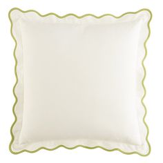 a white and green pillow with scalloped edges