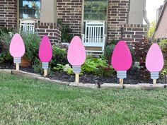 pink and grey garden decorations in front of a house