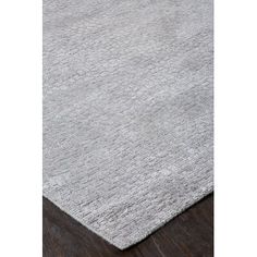 a grey rug on a wooden floor