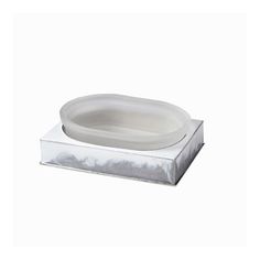 a white bowl sitting on top of a metal stand with a silver tray underneath it