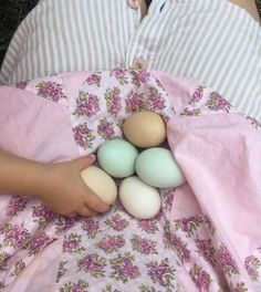 a person laying on the ground with eggs in their stomach