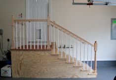 an empty room with a white door and stairs