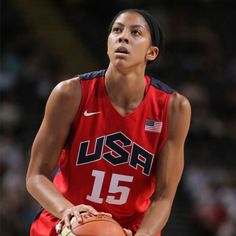 a woman holding a basketball in her right hand and wearing a red uniform with the usa number 15 on it