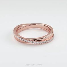 an 18k rose gold wedding band with diamonds on the outside and inside, is shown