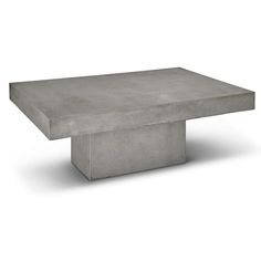 a concrete table sitting on top of a white floor