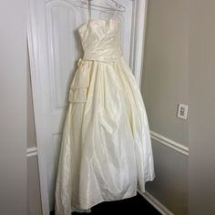 a white dress hanging on a door