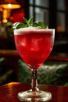 a red drink sitting on top of a wooden table