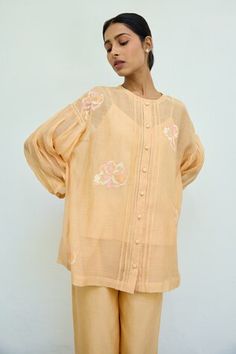 Peach sheer top featuring floral hand embroidery all over with drop shoulders and front button placket. Comes with an inner. - Aza Fashions Summer Embroidered Top With Blouson Sleeves, Summer Tops With Embroidered Sleeves For Daywear, Peach Blouse Piece With Resham Embroidery, Orange Blouse With Floral Embroidery, Traditional Spring Blouse With Set-in Sleeves, Traditional Blouse With Set-in Sleeves For Spring, Orange Long Sleeve Tops For Festive Season, Floral Hand Embroidery, Peach Top