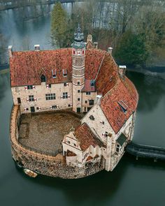 an aerial view of a castle in the water