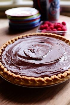 a chocolate pie sitting on top of a wooden table