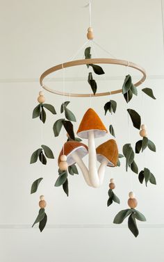 a mobile with mushrooms and leaves hanging from it