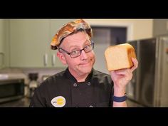 a man holding a piece of bread in his hand