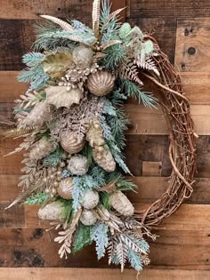 a wreath with pine cones and evergreen leaves